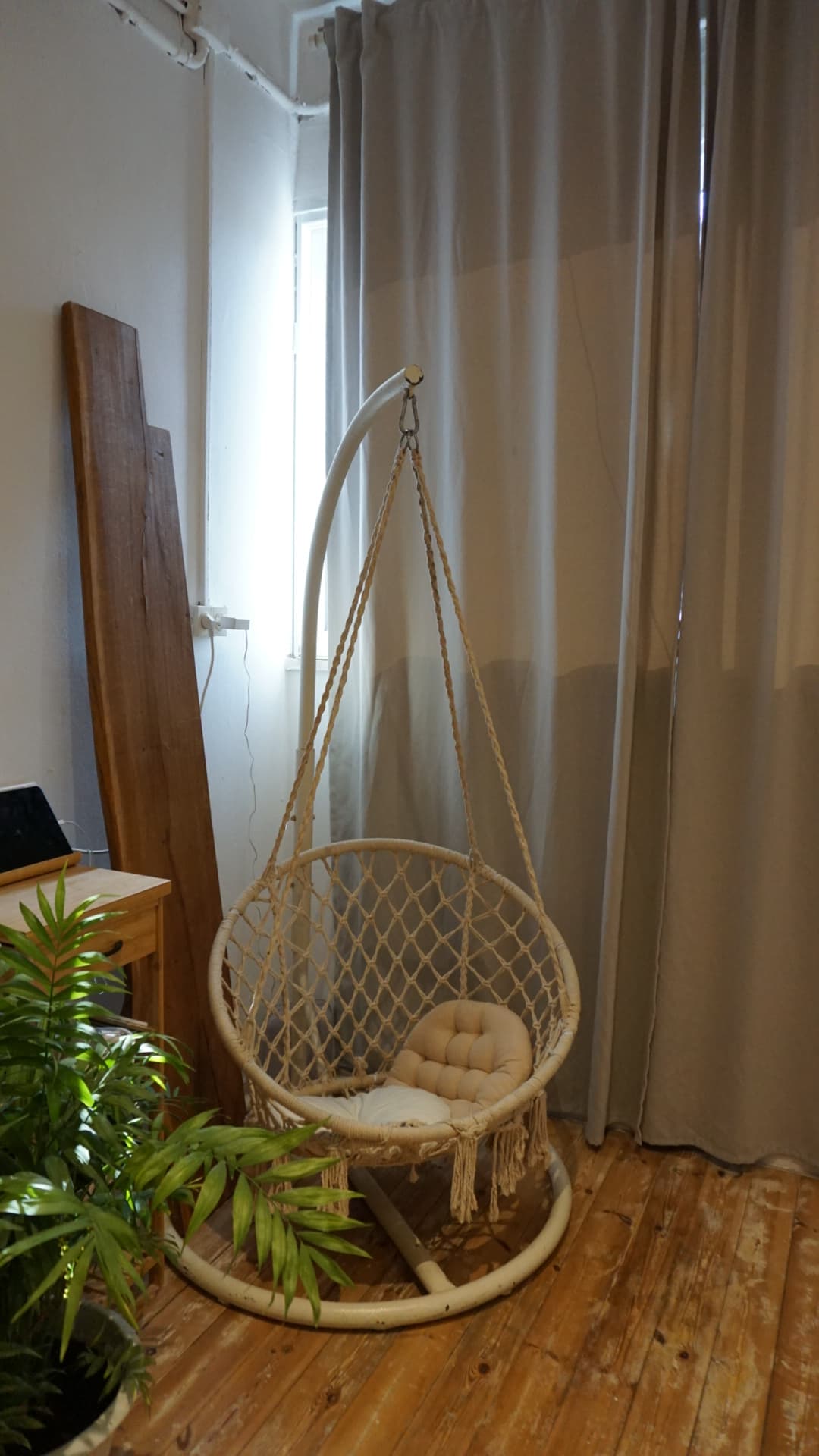 Hanging chair and curtains — soft daylight, wood floor